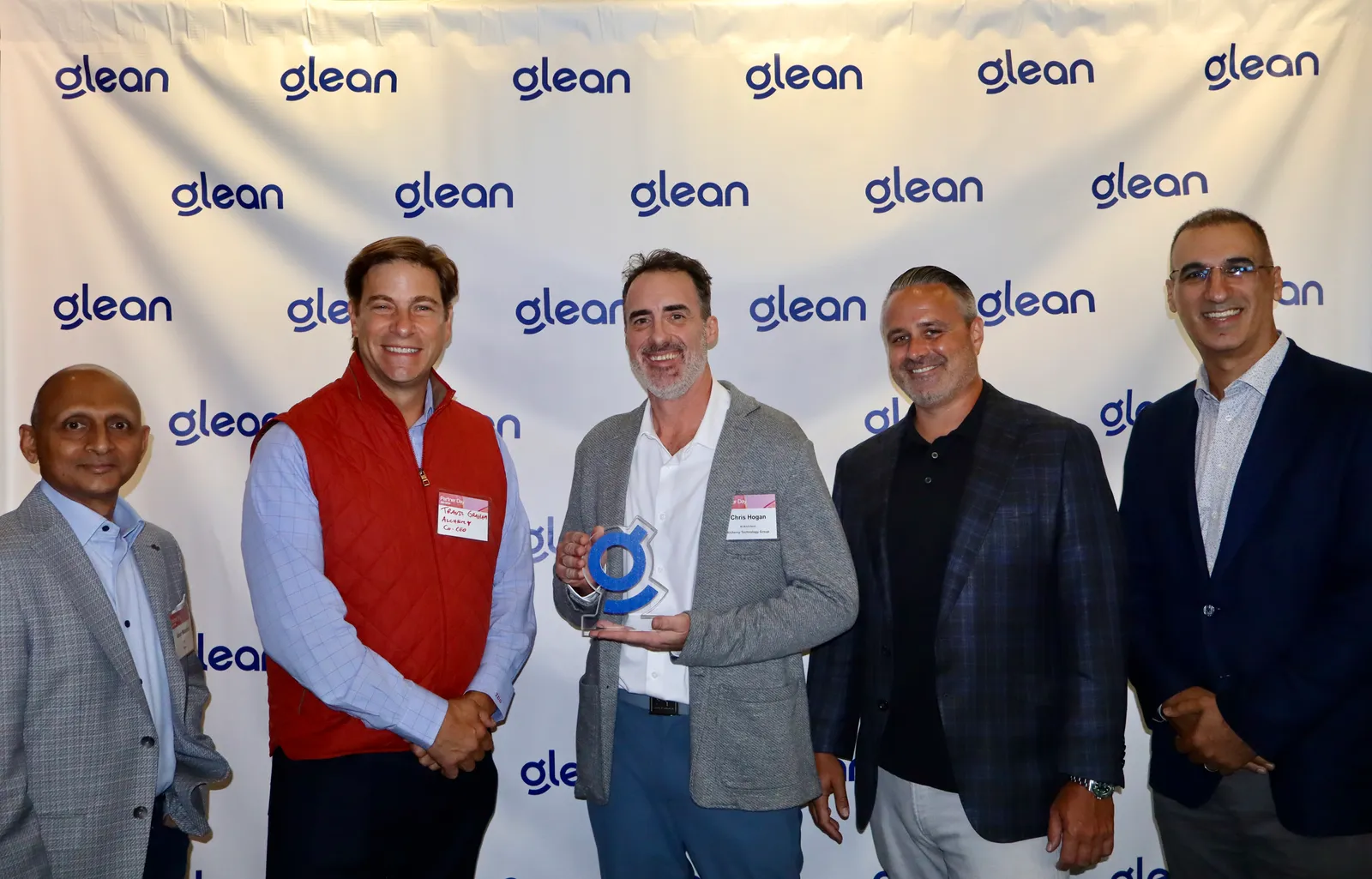 Alchemy Technology Group leaders accepting the 2026 Glean Delivery Excellence Partner of the Year award